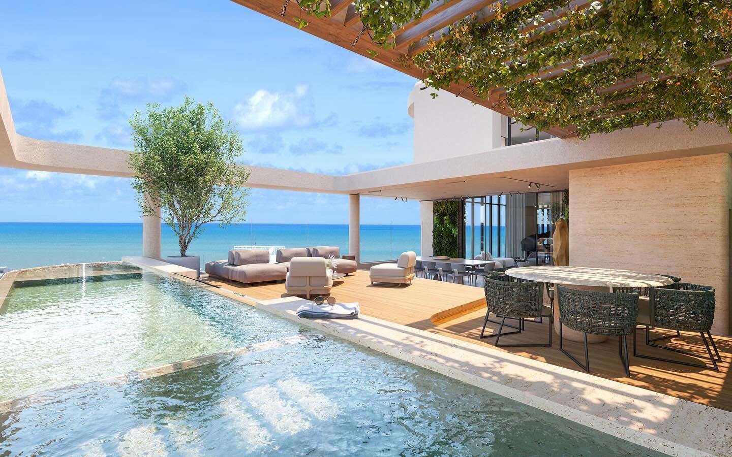 Piscina com borda infinita e vista para o mar, pérgola e mobiliário externo